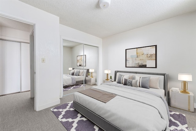 carpeted bedroom featuring a textured ceiling and a closet