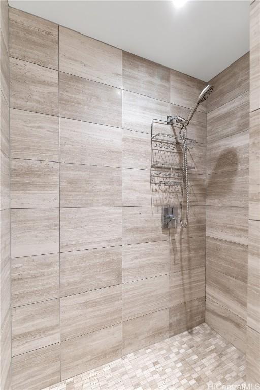 bathroom with tiled shower