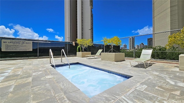 view of swimming pool featuring a community hot tub and a patio