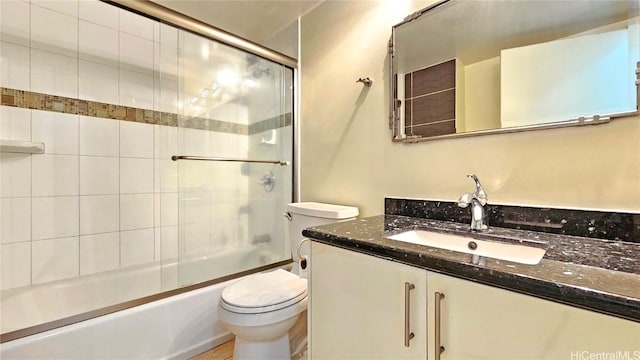 full bathroom with vanity, toilet, and enclosed tub / shower combo