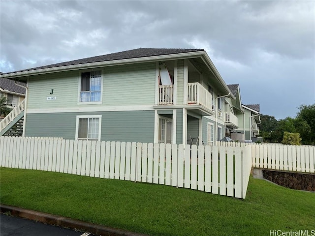 view of side of property with a yard