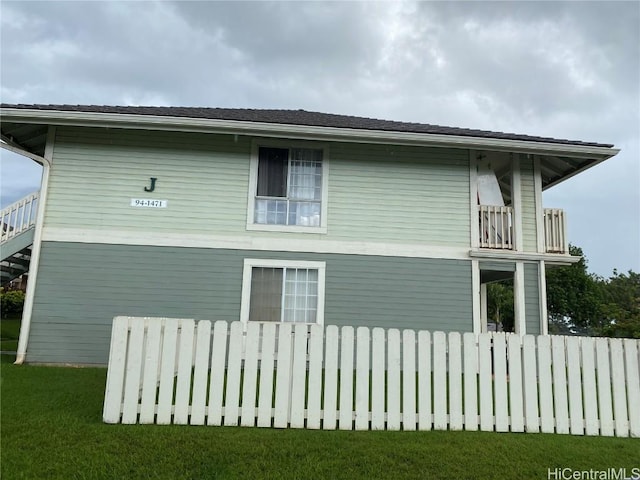 view of side of home with a yard