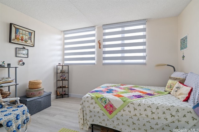 bedroom featuring a textured ceiling and light wood-type flooring