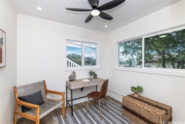 home office with hardwood / wood-style floors and ceiling fan