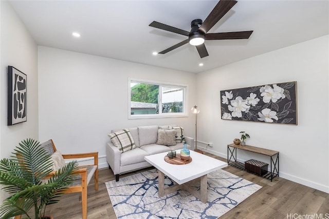 living room featuring ceiling fan and hardwood / wood-style floors