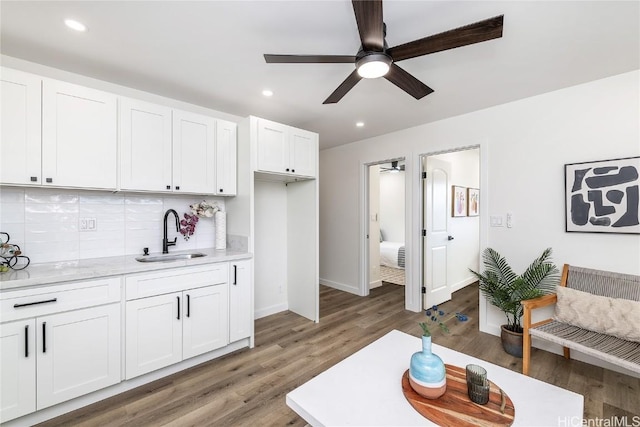 living room with ceiling fan, dark hardwood / wood-style flooring, and sink