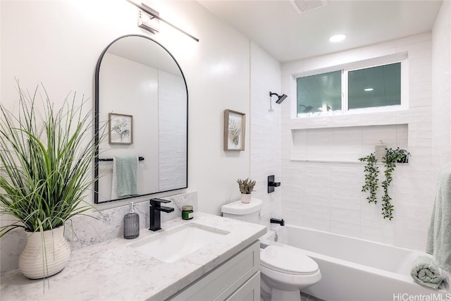 full bathroom featuring vanity, toilet, and tiled shower / bath combo