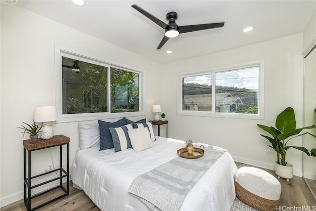 bedroom with light hardwood / wood-style flooring and ceiling fan