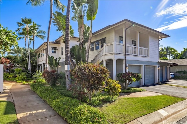 view of front of home featuring a balcony and a garage