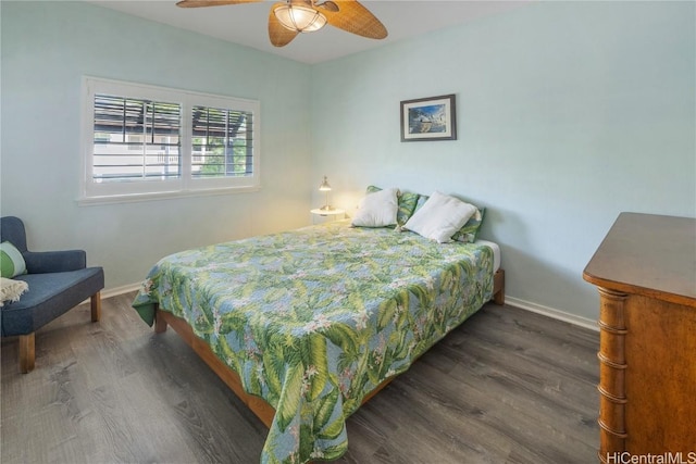 bedroom with dark hardwood / wood-style floors and ceiling fan