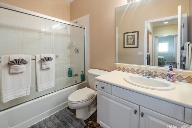 full bathroom with vanity, toilet, and enclosed tub / shower combo