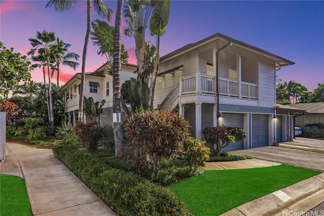 view of front of property with a garage and a balcony