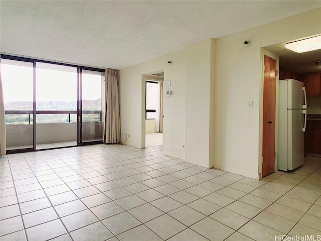 tiled empty room featuring a mountain view