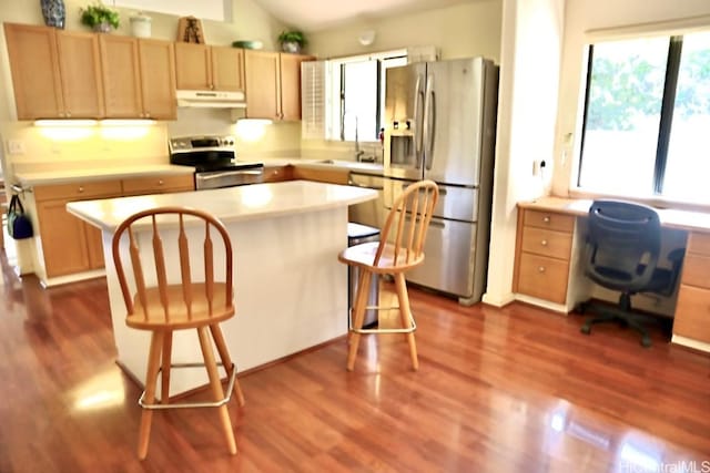 kitchen with stainless steel appliances, vaulted ceiling, dark wood-type flooring, and sink