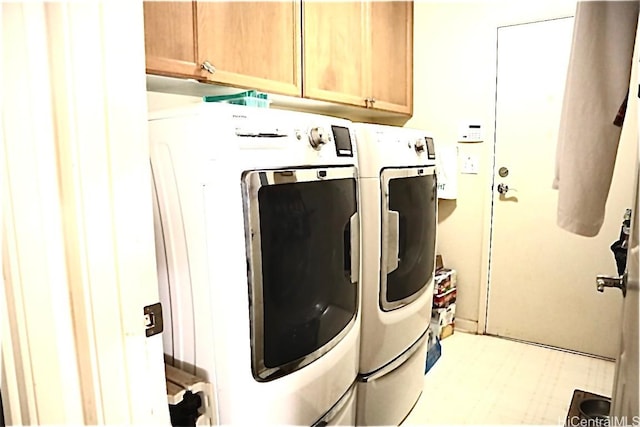 laundry area with cabinets and washing machine and dryer