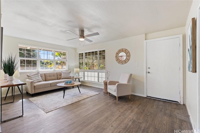 living room featuring a textured ceiling, ceiling fan, and dark hardwood / wood-style floors