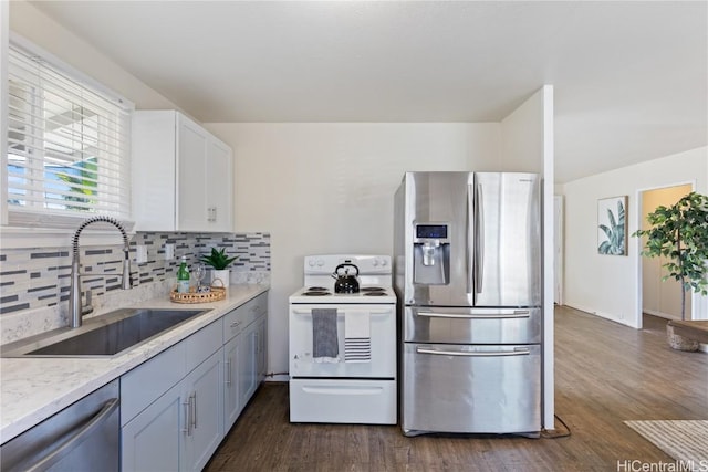 kitchen with decorative backsplash, appliances with stainless steel finishes, dark hardwood / wood-style flooring, sink, and white cabinetry