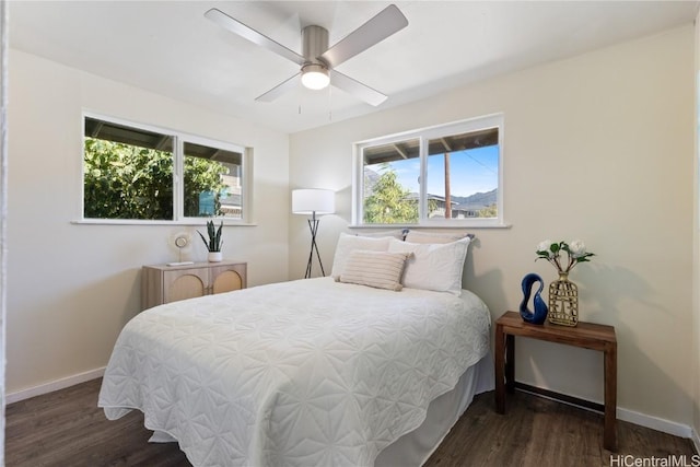 bedroom with multiple windows, ceiling fan, and dark hardwood / wood-style floors