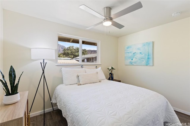 bedroom featuring ceiling fan and dark hardwood / wood-style floors