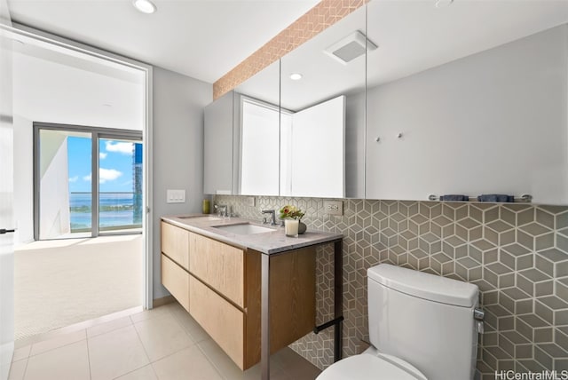 bathroom with tile patterned floors, vanity, and toilet