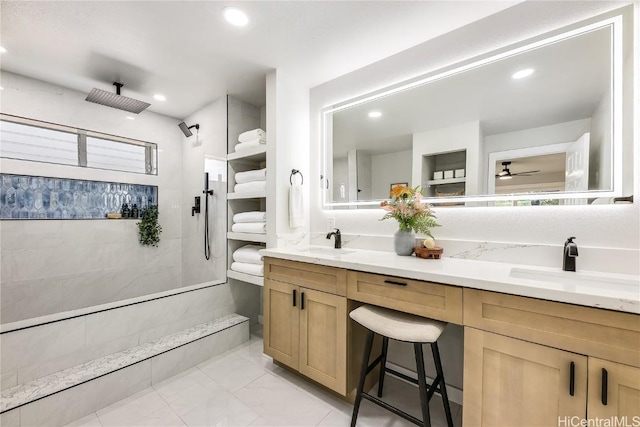 bathroom featuring vanity, ceiling fan, and walk in shower