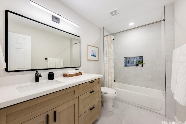 full bathroom featuring shower / bath combo, vanity, and toilet