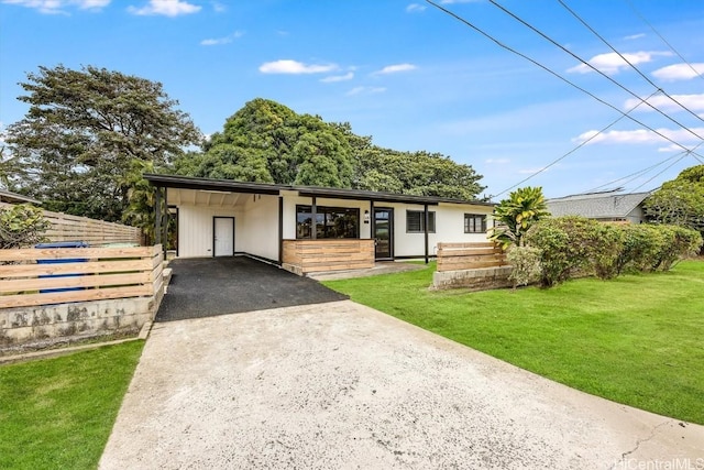 ranch-style house with a carport and a front lawn