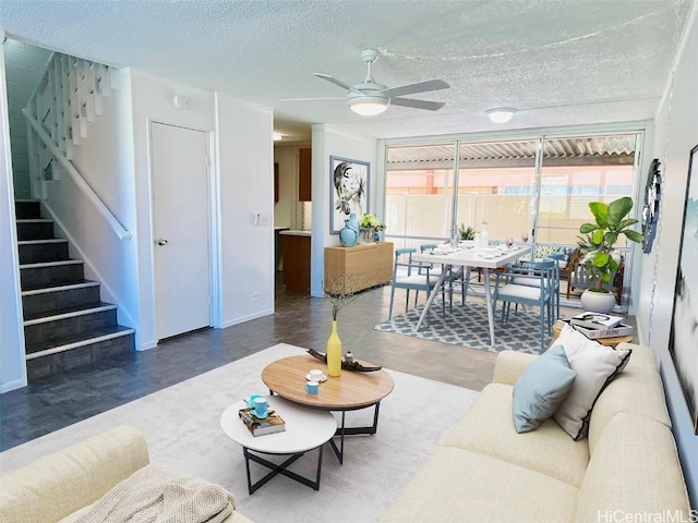 living room featuring a textured ceiling and ceiling fan