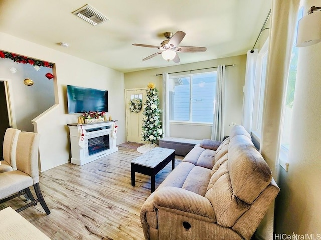 living room featuring light wood-type flooring and ceiling fan