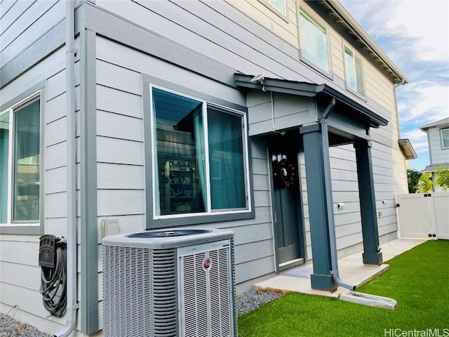 view of side of property featuring central air condition unit