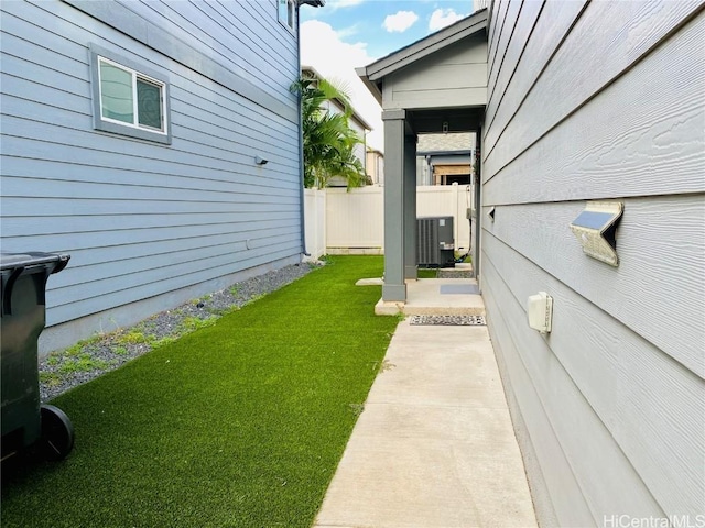 entrance to property featuring a yard and central AC