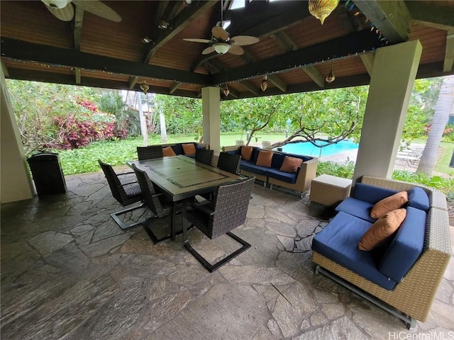 view of patio / terrace featuring a gazebo, an outdoor living space, ceiling fan, and a pool