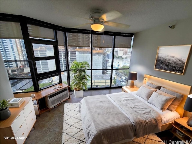 bedroom with a wall of windows and a wall unit AC