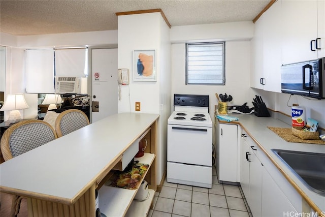 kitchen featuring sink, a textured ceiling, white cabinetry, and electric stove