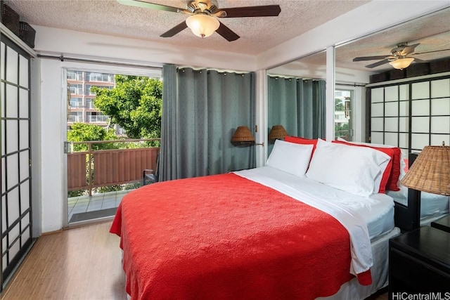 bedroom with ceiling fan, a textured ceiling, access to outside, and light hardwood / wood-style flooring