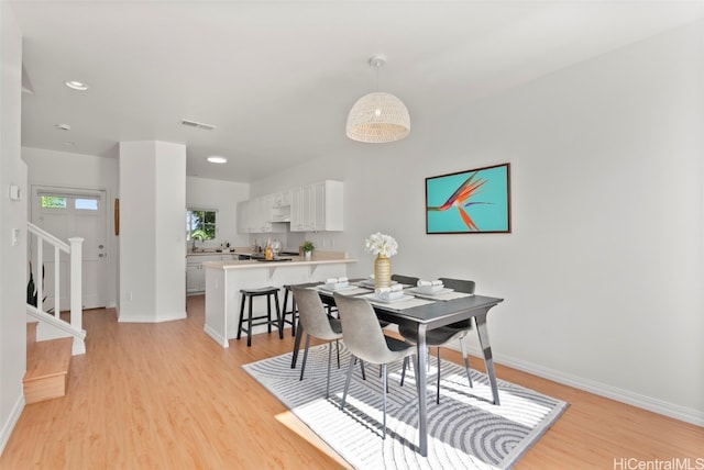 dining space with light wood-type flooring