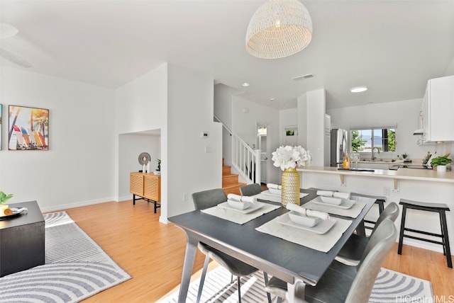 dining space featuring light hardwood / wood-style floors and sink