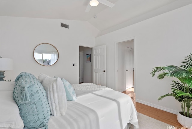 bedroom with light wood-type flooring, ceiling fan, and lofted ceiling