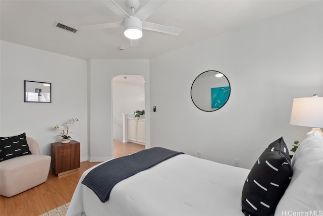 bedroom featuring ensuite bath, ceiling fan, and light hardwood / wood-style flooring