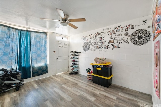 misc room with hardwood / wood-style flooring and ceiling fan