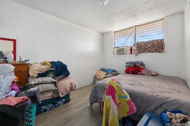 bedroom featuring cooling unit and light hardwood / wood-style flooring