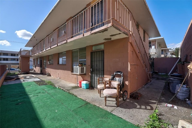 exterior space with cooling unit and a balcony