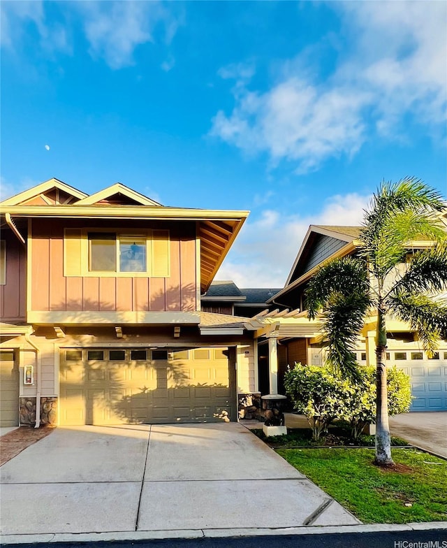 92-7139 Elele St Unit 805, Kapolei, HI 96707 - view of front of property featuring concrete driveway, board and batten siding, a garage, and stone siding