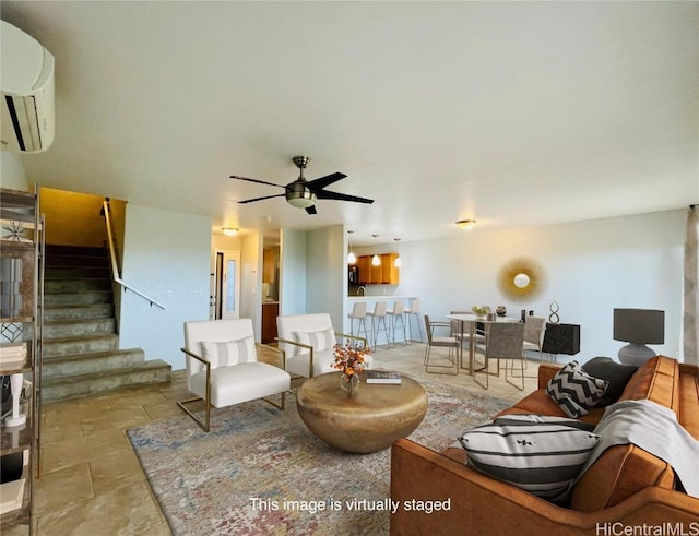 living room with a wall unit AC and ceiling fan