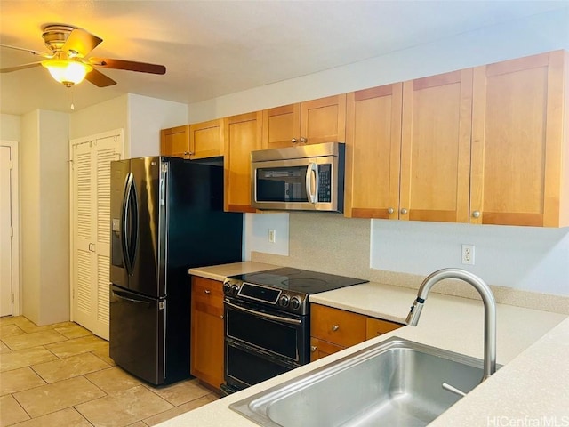 kitchen featuring ceiling fan, light tile patterned floors, sink, and appliances with stainless steel finishes