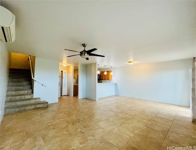 unfurnished living room featuring a wall unit AC and ceiling fan