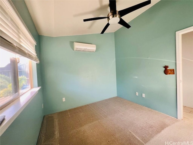 empty room with carpet flooring, an AC wall unit, ceiling fan, and lofted ceiling