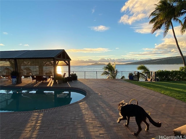 view of pool featuring a gazebo, a patio area, and a water and mountain view