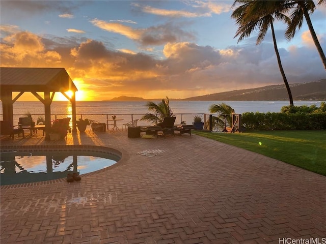 exterior space featuring a gazebo, a patio area, and a water view