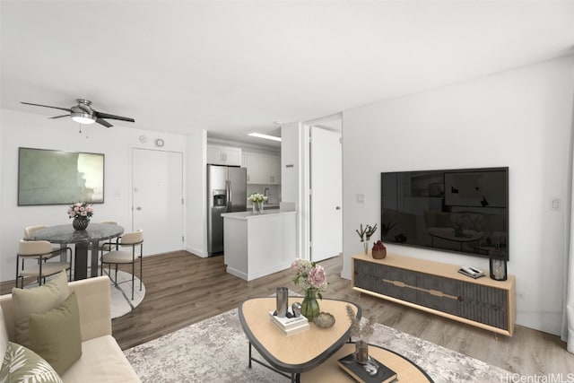 living room featuring ceiling fan and dark wood-type flooring